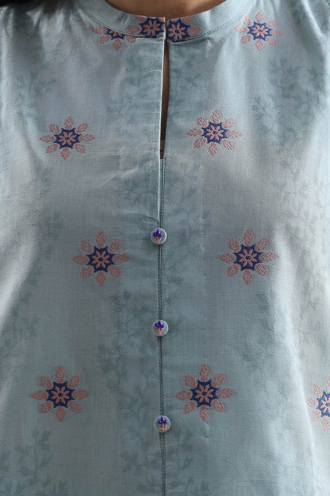 Light blue kurta with floral patterns on a plain background