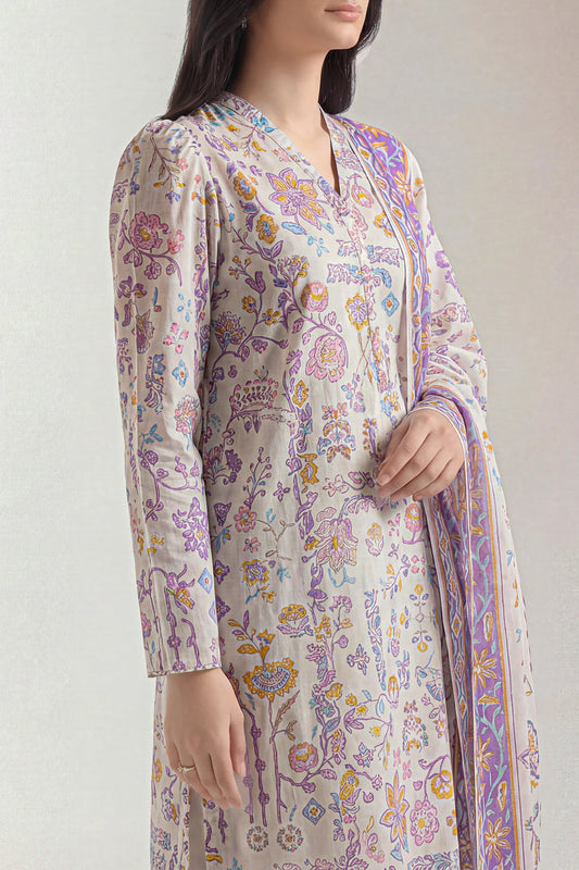 Woman wearing a floral patterned kurta with a matching dupatta on a plain background
