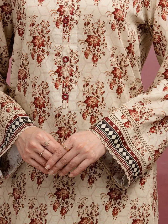 Close-up of a person wearing a traditional outfit with floral patterns on a pink background