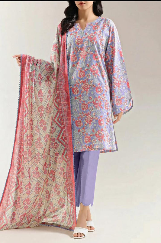 Woman wearing a floral kurta with a matching dupatta and purple pants on a plain background
