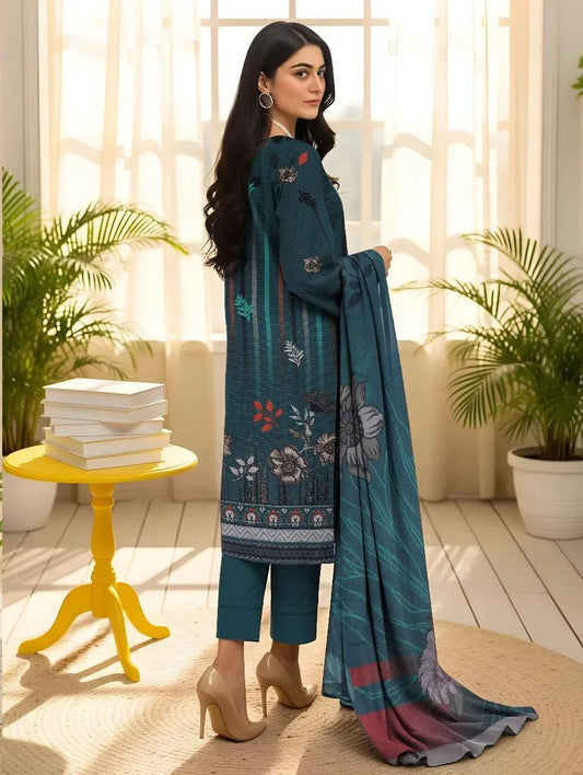 Woman holding a blue embroidered dupatta in a bright room with plants and books.