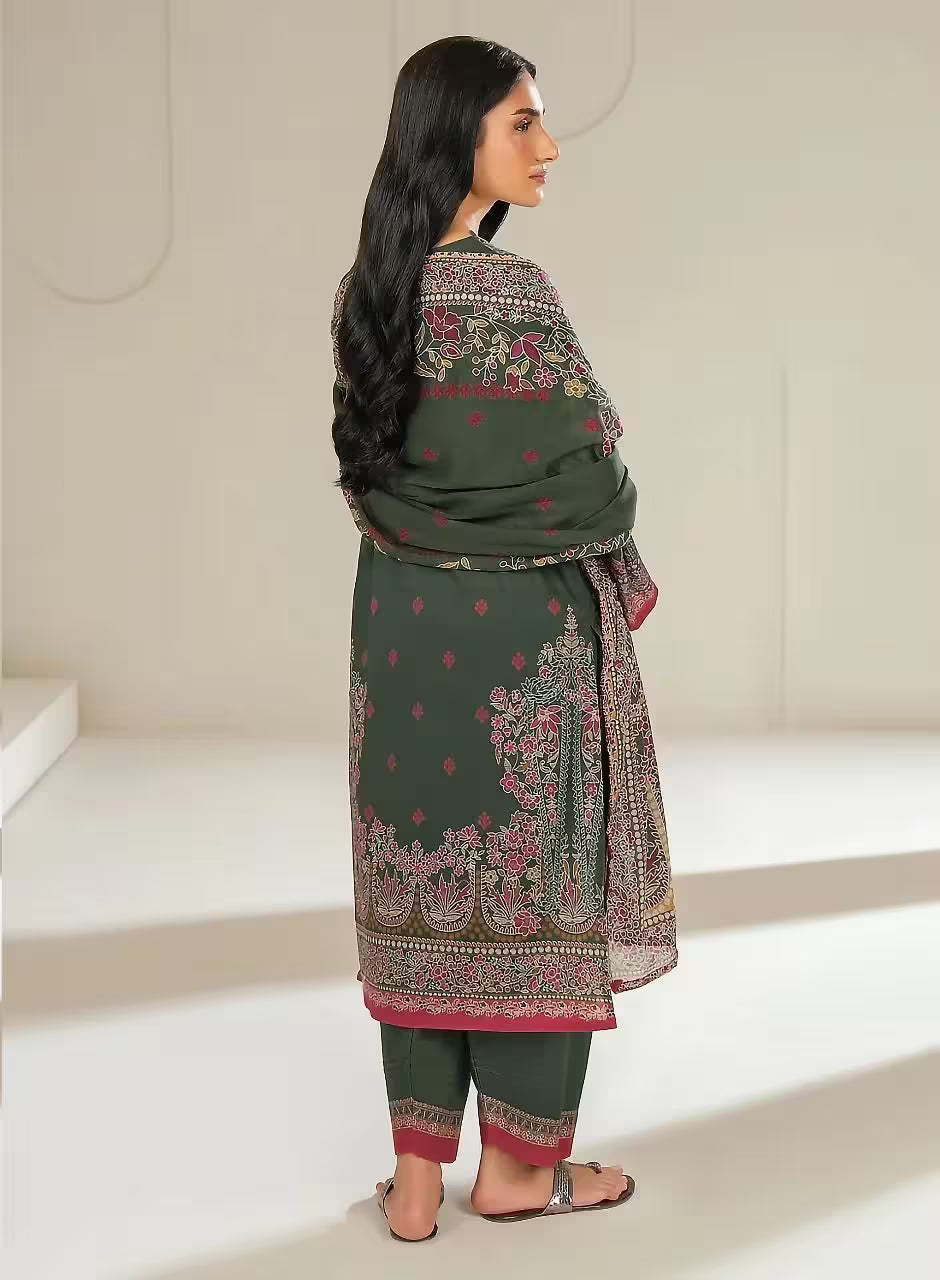 Woman wearing a green traditional outfit with floral patterns in a minimalistic setting