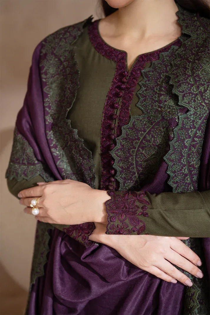 Traditional outfit with green and purple patterns on a plain background