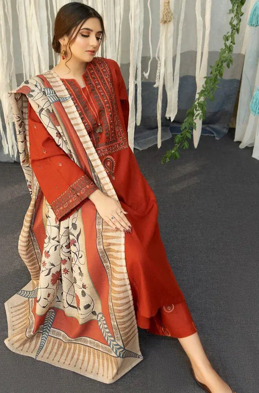 Woman wearing a red and beige traditional outfit with a matching dupatta indoors.