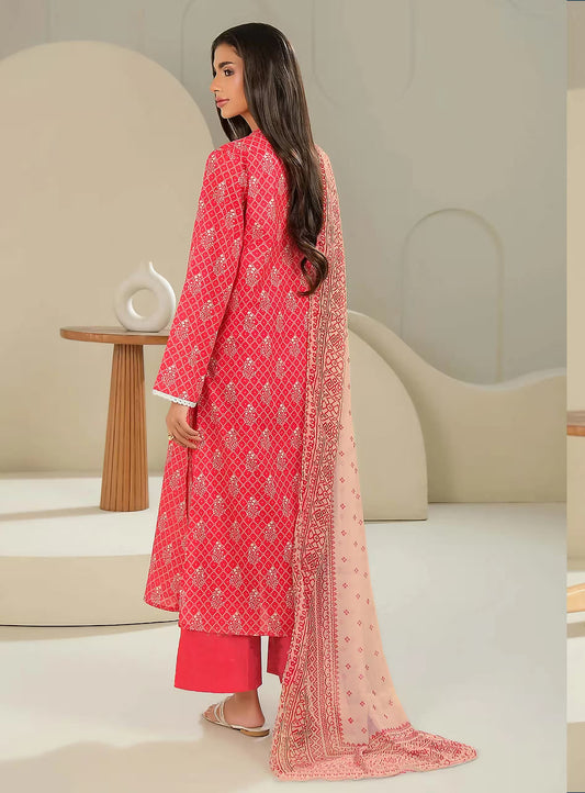 Woman wearing a red embroidered outfit with a matching dupatta in a minimalistic setting.