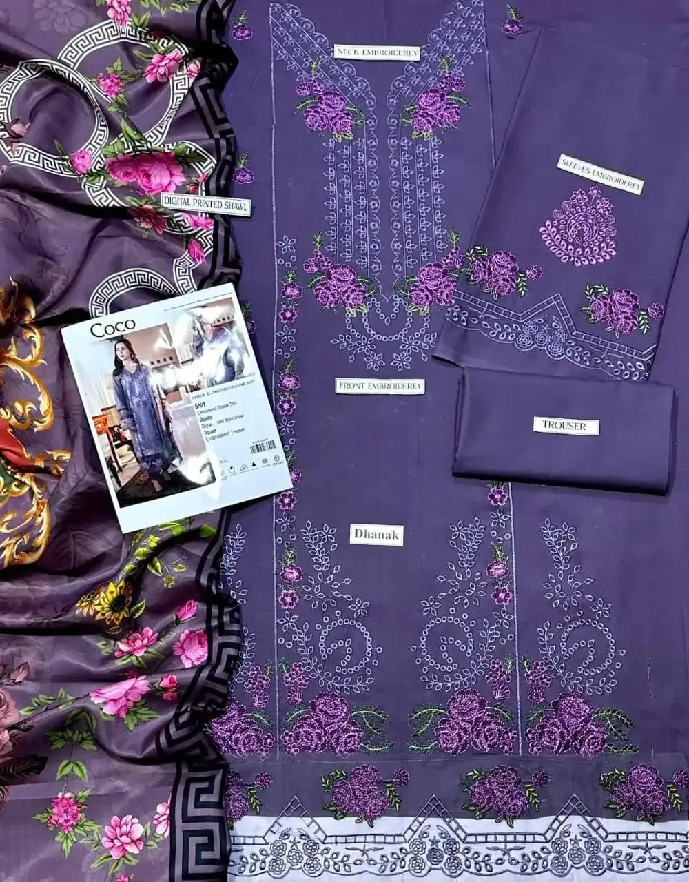 Purple fabric with floral embroidery and a magazine featuring fashion models.