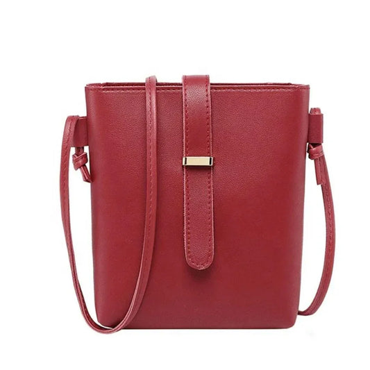 Red handbag with a strap on a white background