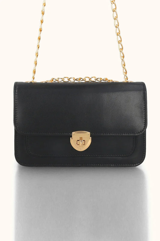 Black handbag with a gold chain strap on a white background