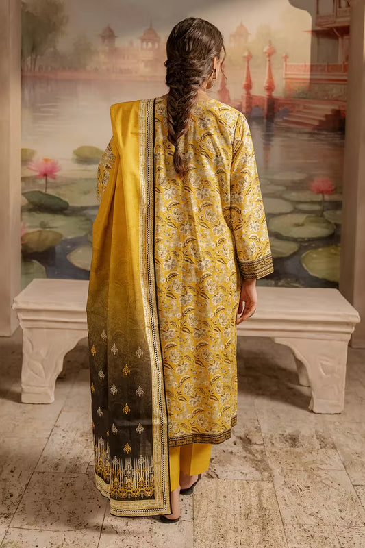 Woman in a yellow and black patterned outfit standing in front of a scenic mural.