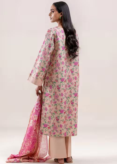 Woman wearing a floral kurta with a pink dupatta on a white background