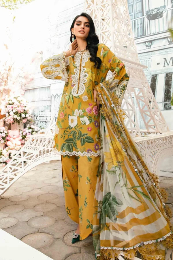 Woman wearing a yellow floral outfit with a matching dupatta in an outdoor setting.