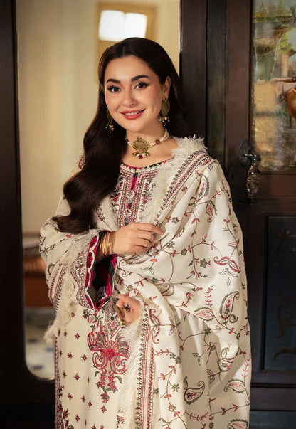 Woman wearing a traditional embroidered outfit indoors