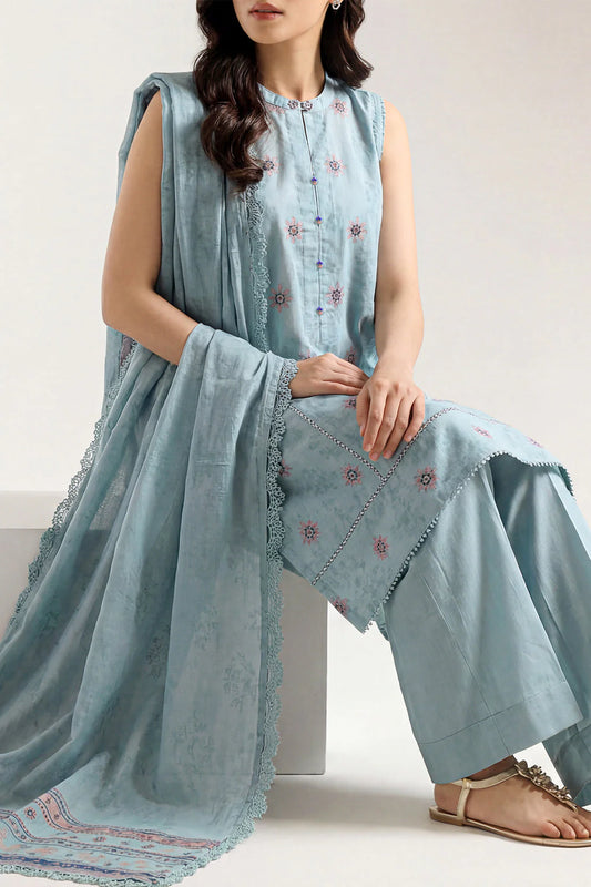 Woman wearing a light blue embroidered outfit with a matching dupatta on a white background