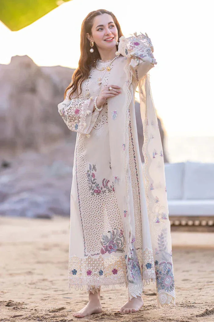 Woman in a traditional embroidered outfit with a floral shawl outdoors.