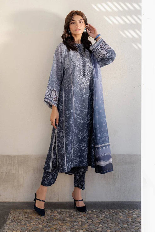 Woman wearing a blue embroidered traditional outfit against a neutral background