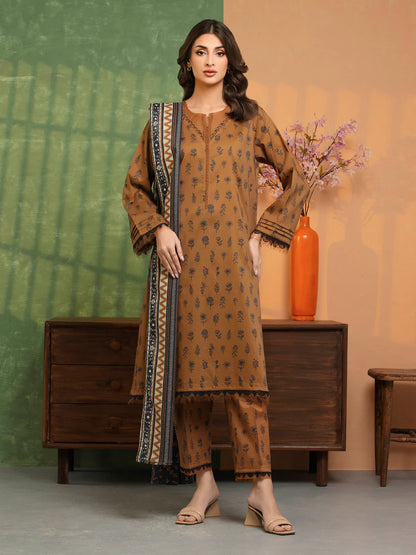 Woman wearing a brown traditional outfit with a patterned dupatta in a room setting.