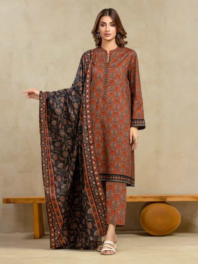 Woman wearing a patterned outfit with a long scarf against a beige background