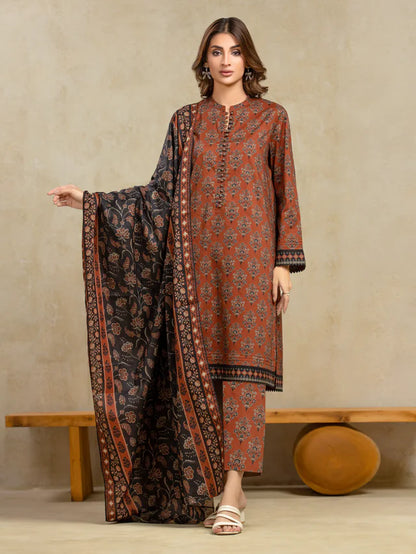 Woman wearing a patterned outfit with a long scarf against a beige background