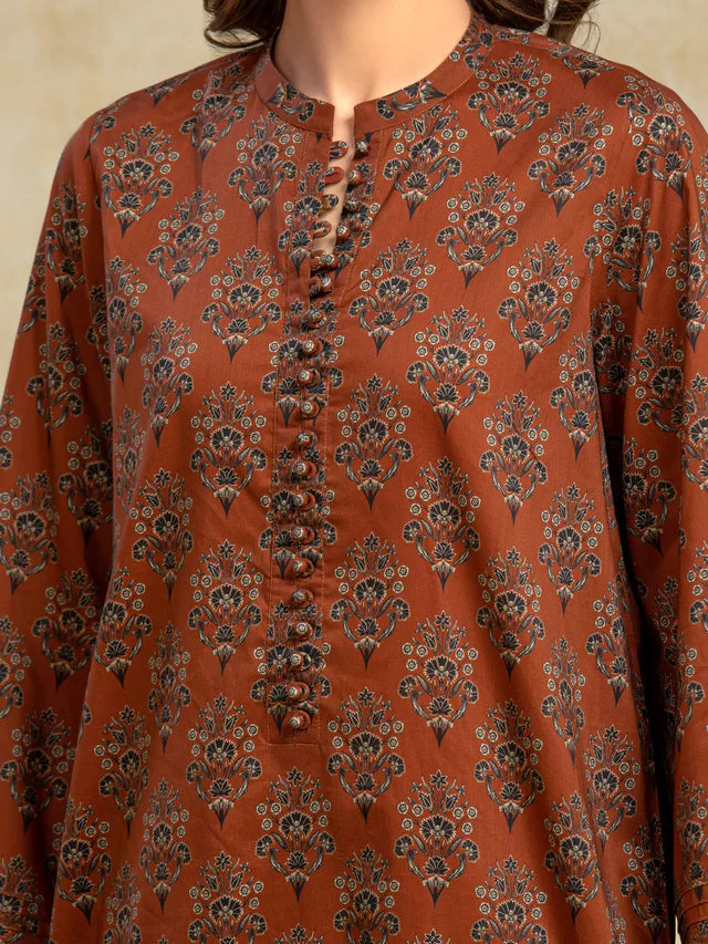 Brown patterned shirt worn by a person on a beige background
