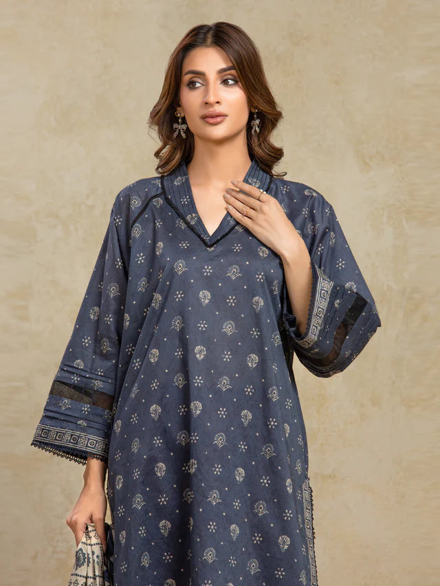 Woman wearing a dark blue patterned kurta against a beige background
