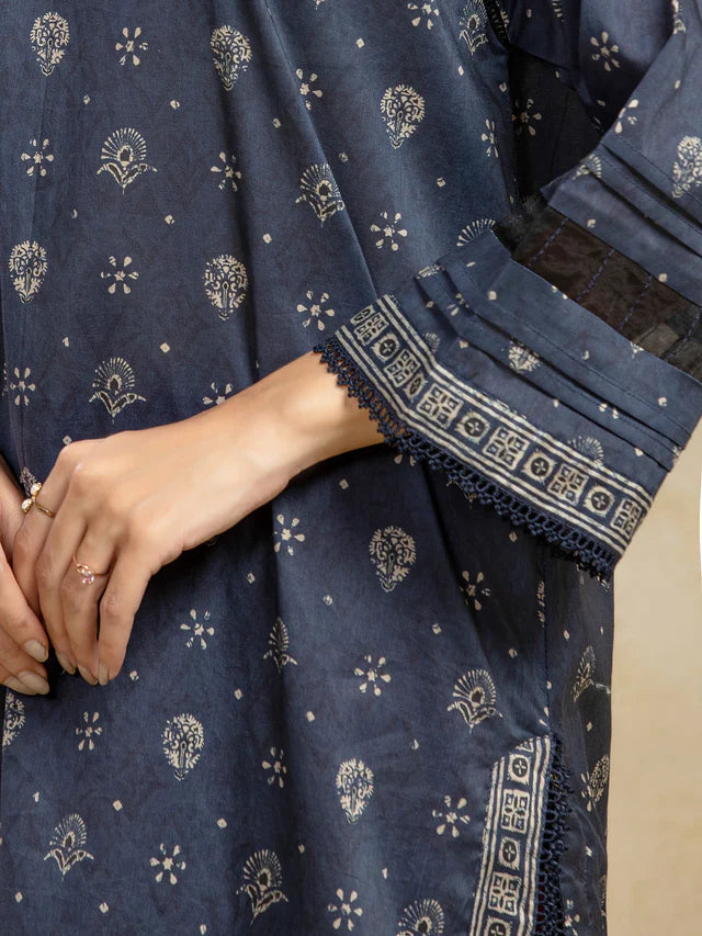 Navy blue fabric with intricate white patterns and lace trim, held by a hand.