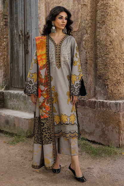 Woman in traditional outfit with floral and leopard print design standing against a rustic wall.
