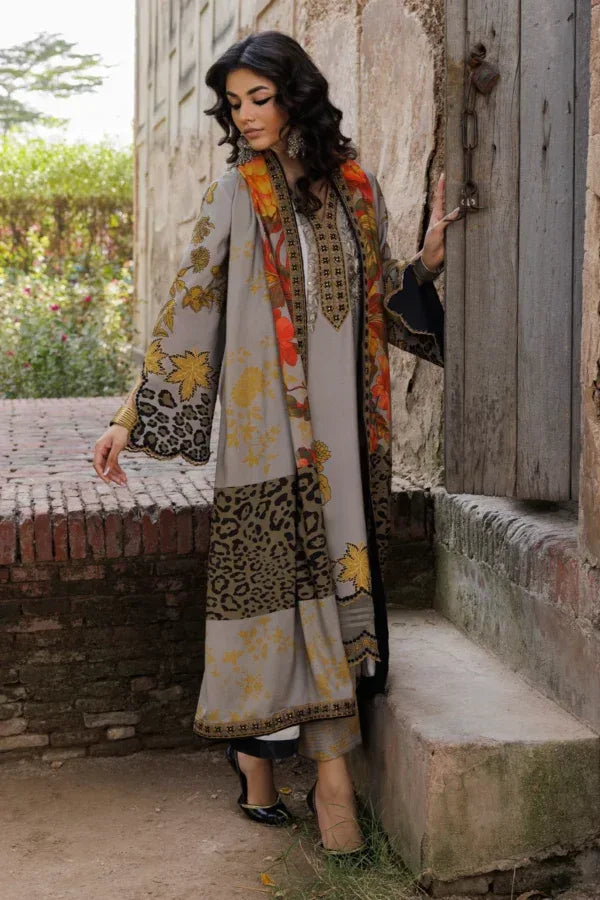 Woman in a patterned outfit standing outdoors near a rustic door.