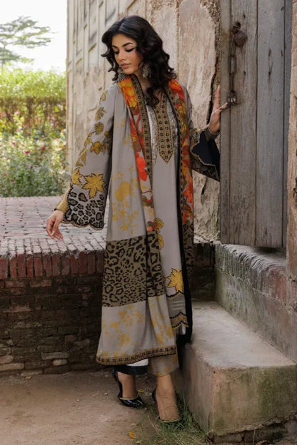 Woman in a patterned outfit standing outdoors near a rustic door.