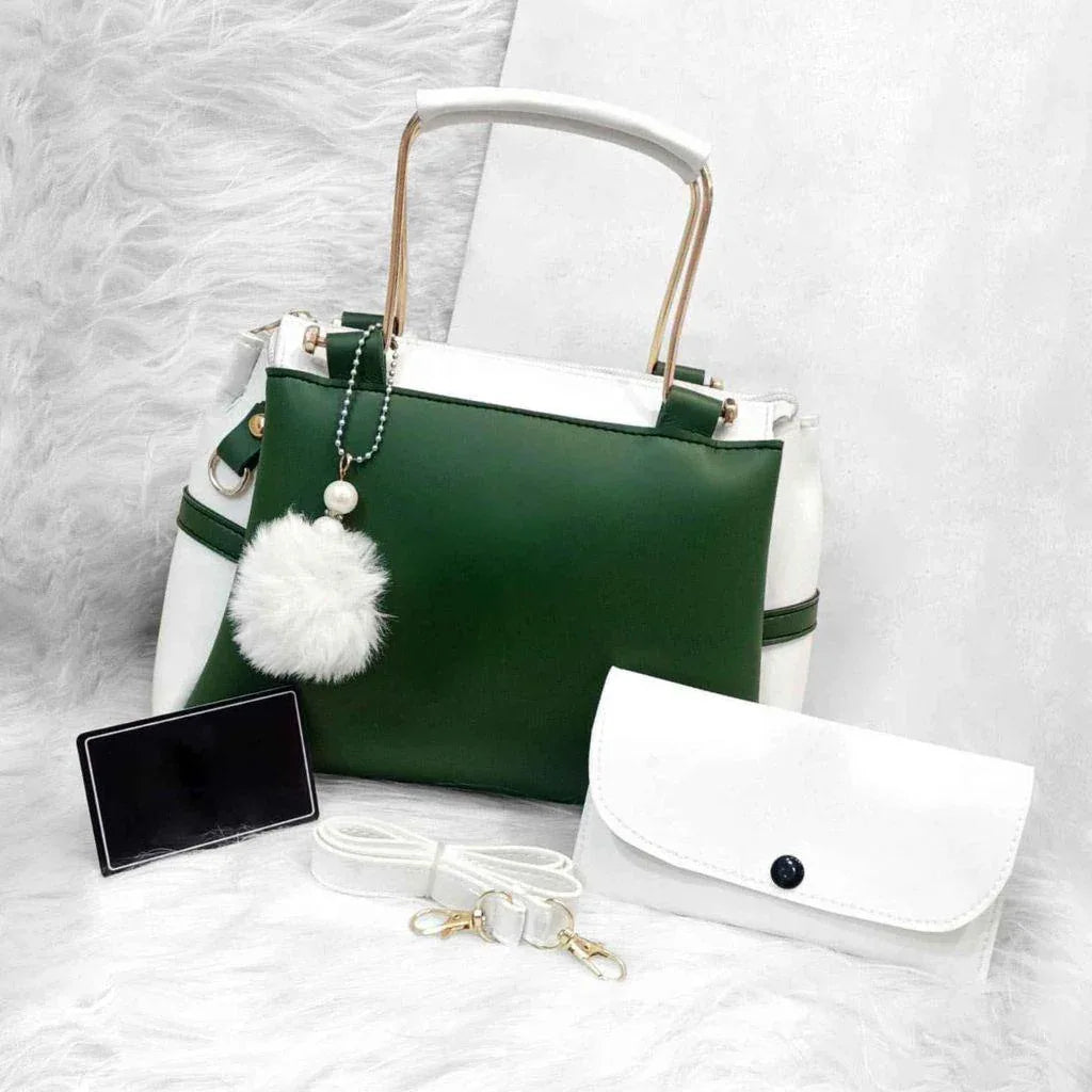 Green handbag with white accents and a matching pouch on a textured white surface