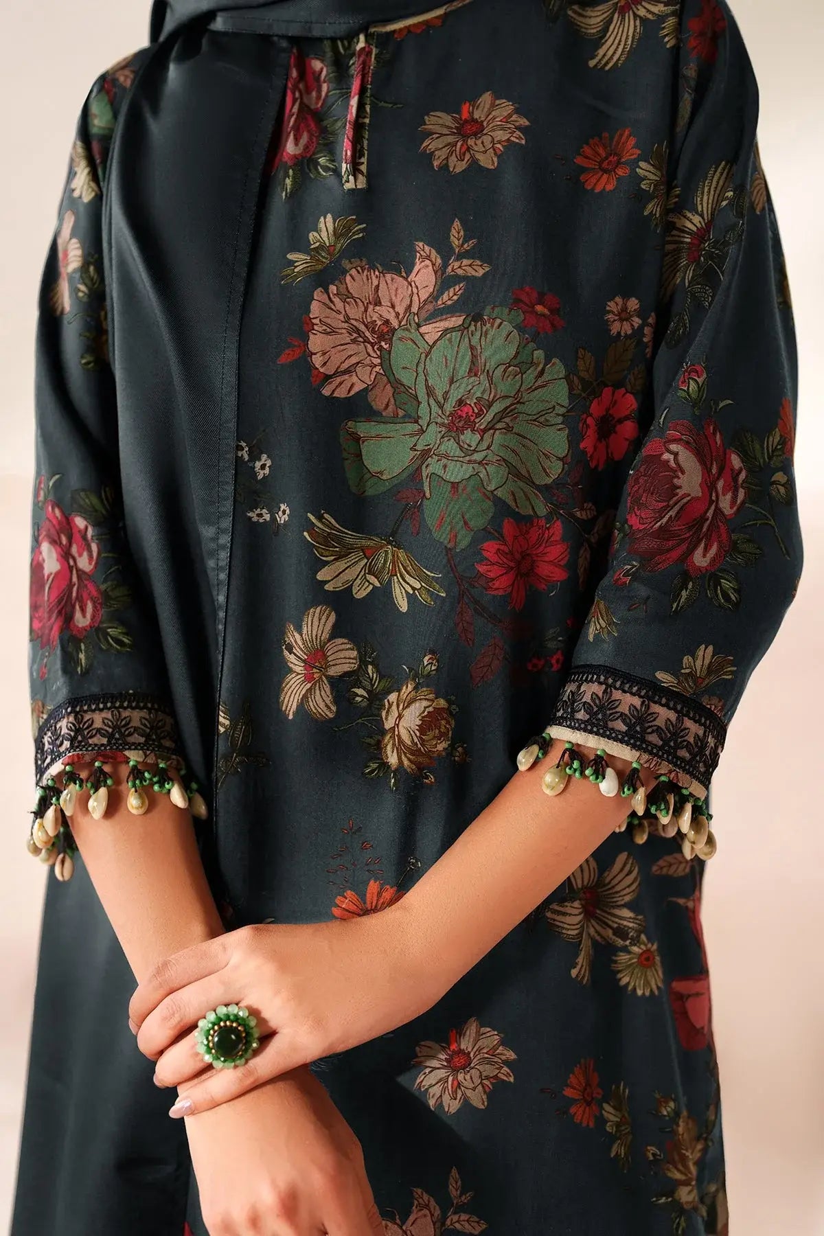 Dark floral dress with intricate patterns on a plain background