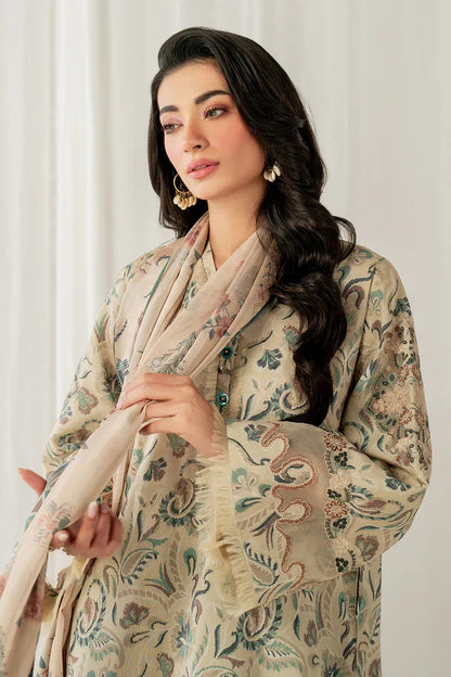Woman holding a floral shawl against a white curtain background