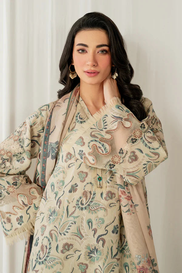 Woman wearing a traditional embroidered outfit against a plain background