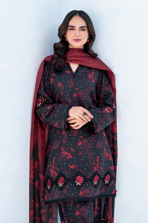 Woman wearing a black floral dress with a red dupatta against a white background