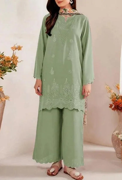 Green embroidered outfit with wide-leg pants on a neutral background