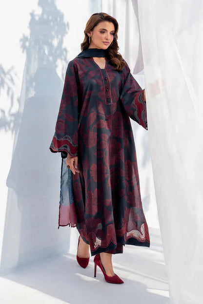 Woman wearing a long, patterned dress with red shoes against a white background