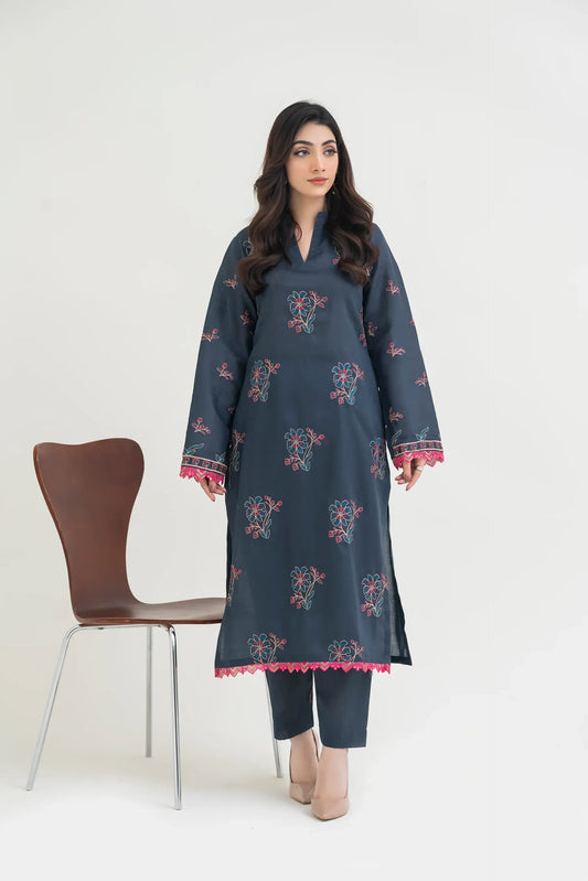 Woman wearing a dark blue embroidered kurta with pink details on a white background