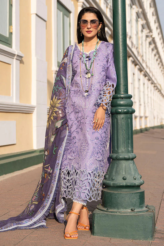Woman in a purple embroidered outfit standing next to a green lamp post.