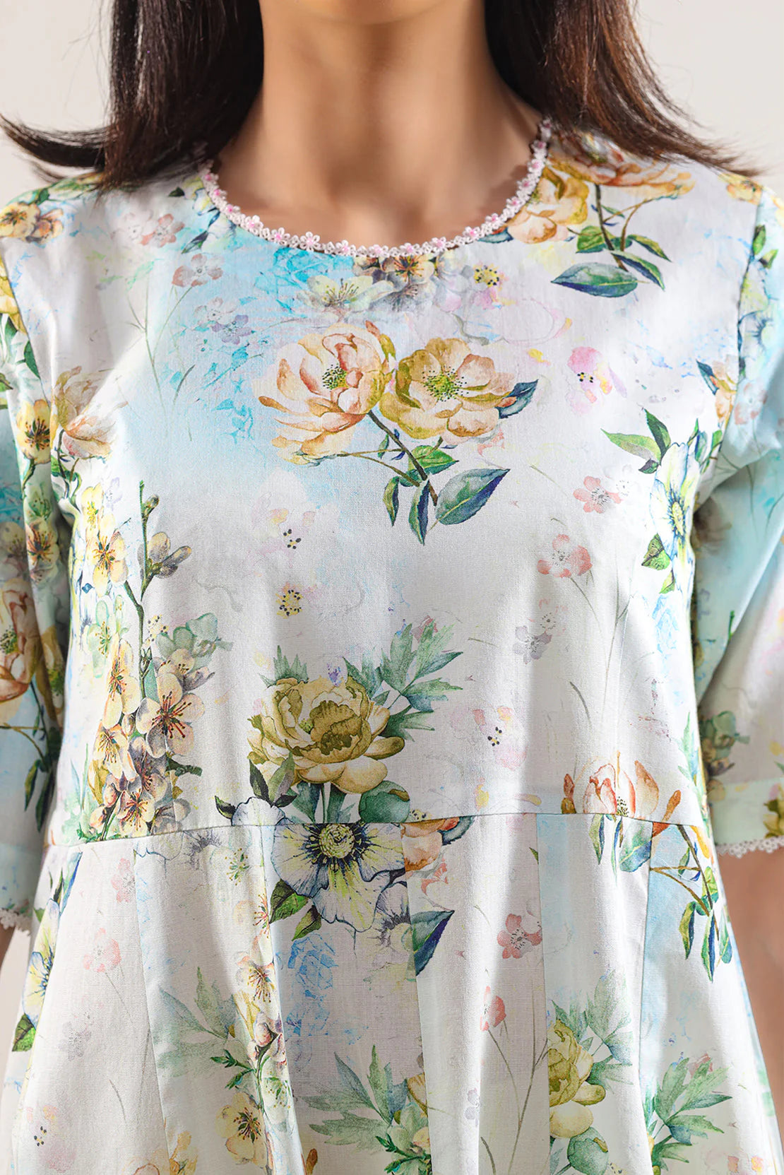 Floral dress with a soft focus on a person wearing it.