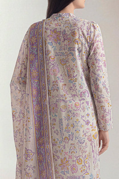 Woman wearing a floral patterned outfit with a sheer dupatta on a plain background