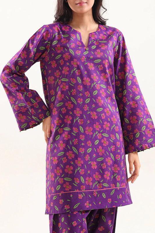 Woman wearing a purple floral patterned outfit on a white background