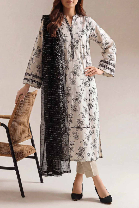 Woman wearing a floral kurta with a black dupatta, standing against a neutral background.