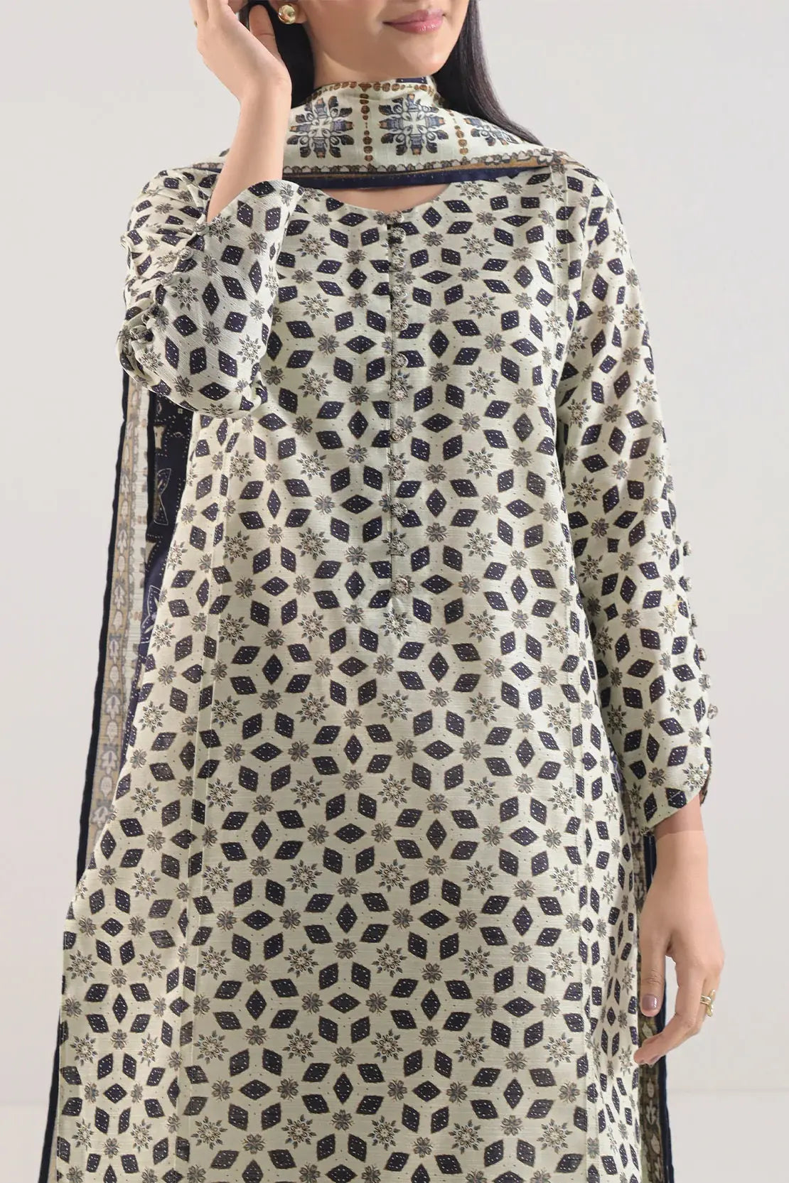 Woman wearing a patterned dress with a plain background