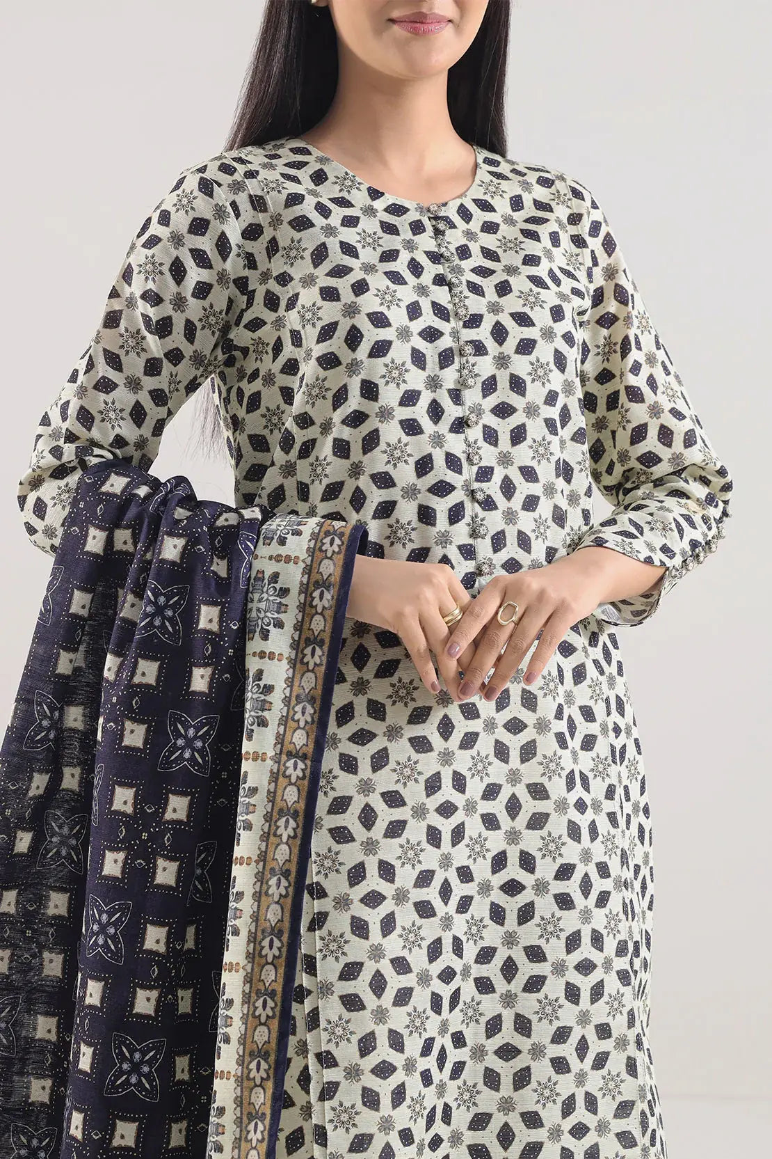 Woman wearing a patterned kurta with a plain background