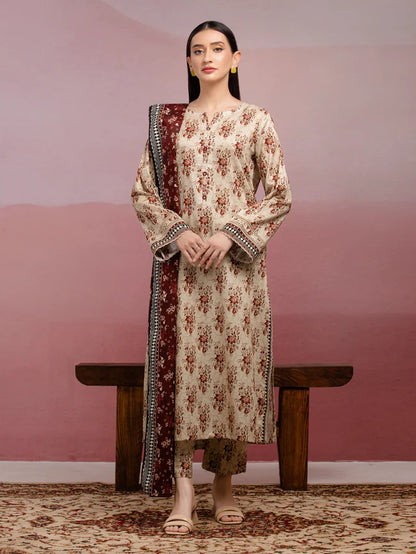 Woman wearing a floral kurta with a long jacket against a pink wall.