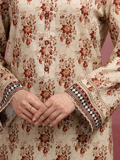 Close-up of a person wearing a traditional outfit with floral patterns on a pink background