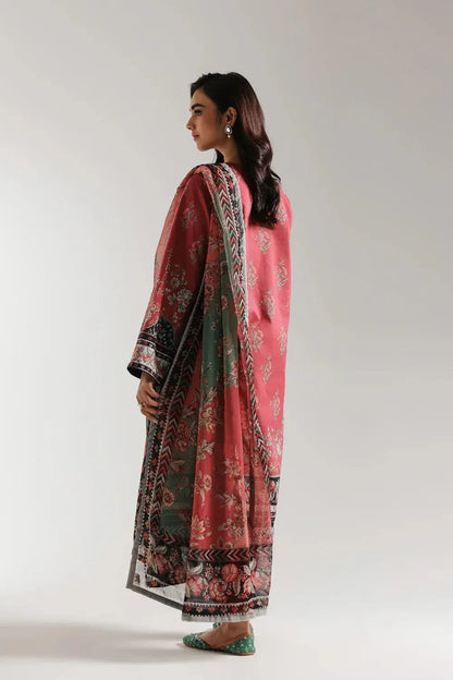 Woman wearing a pink traditional outfit with a patterned dupatta on a white background