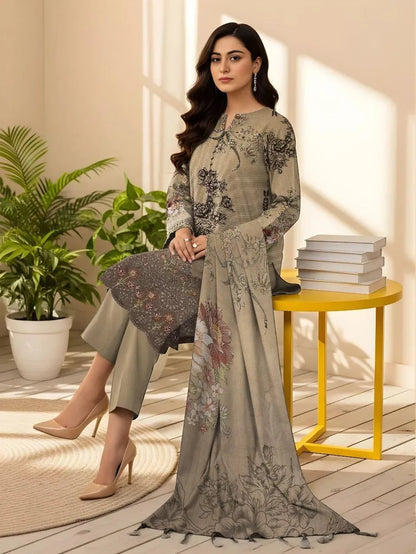 Woman in a floral dress standing next to a yellow table with books and a plant in a well-lit room.