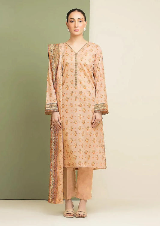 Woman wearing a peach embroidered outfit with a green and beige background