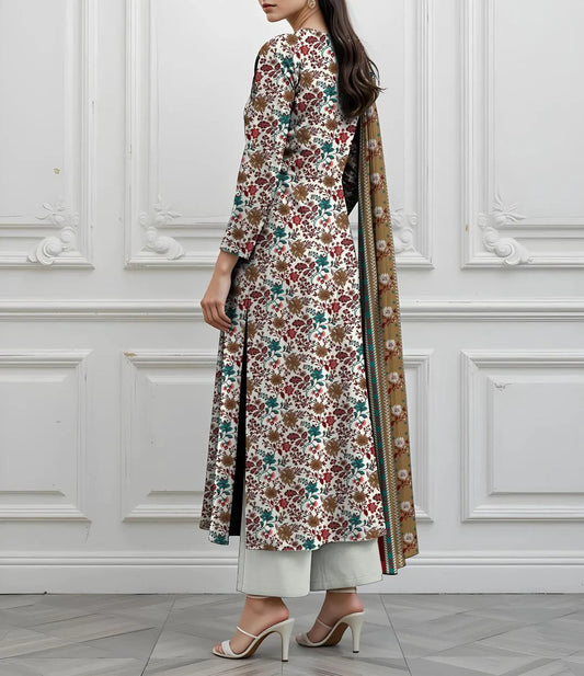 Woman wearing a floral dress with a matching shawl against a white paneled wall.