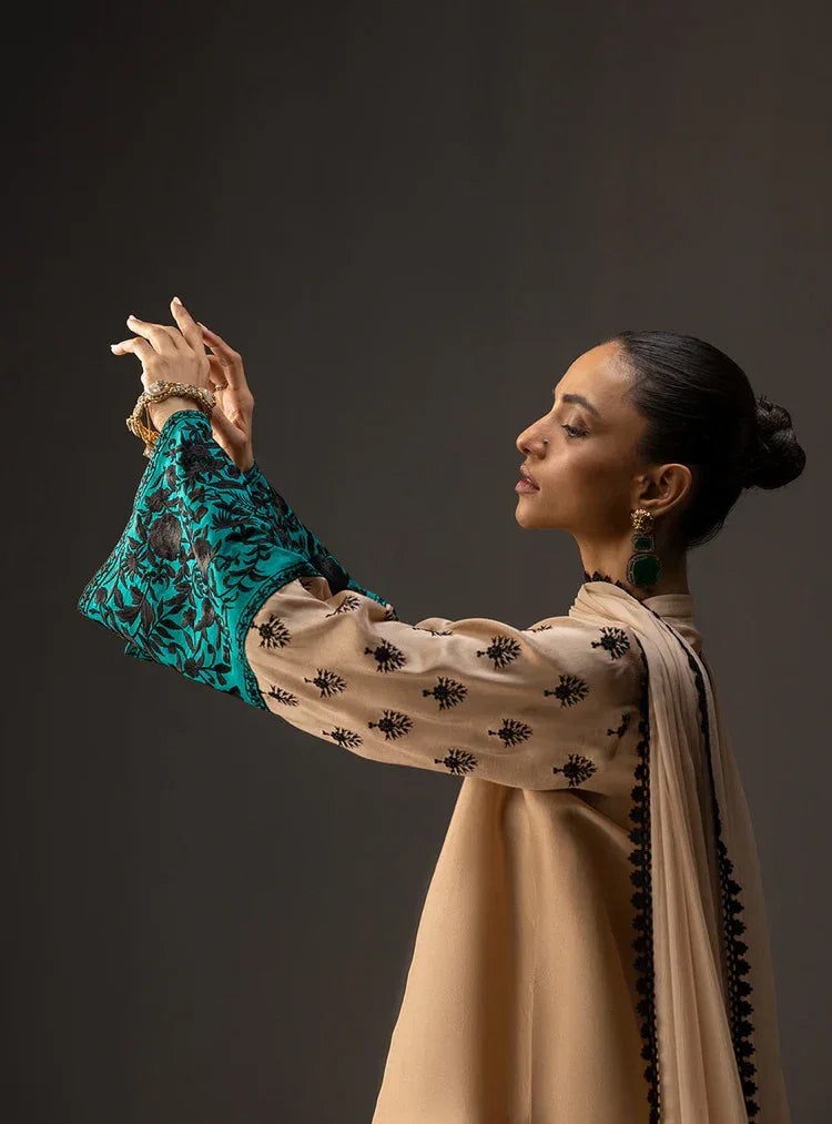 Woman in traditional attire with a dark background